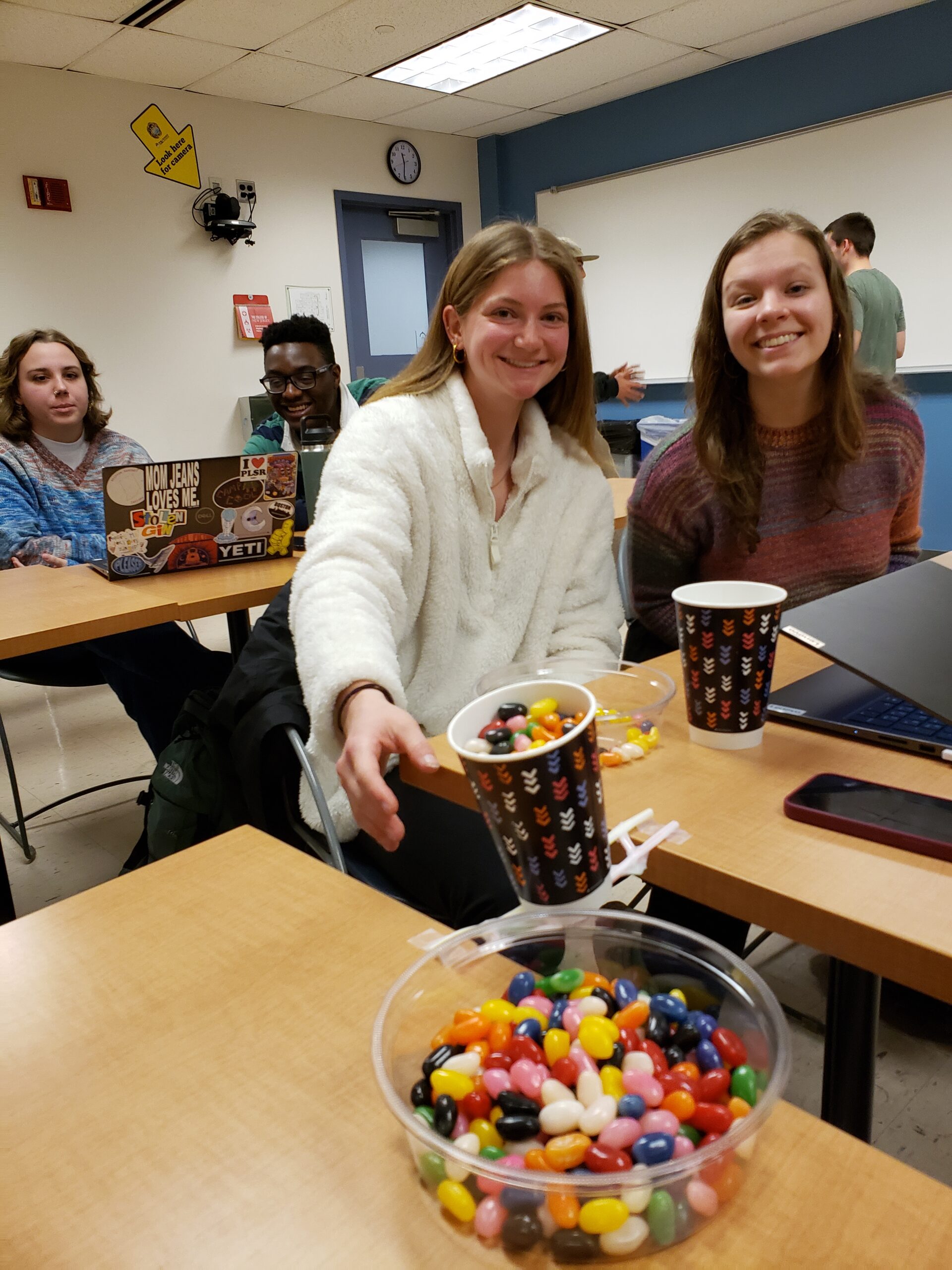 Seniors Julie Stone and Erin Swierczyna sitting behind a desk that shows bridge loading in progress.