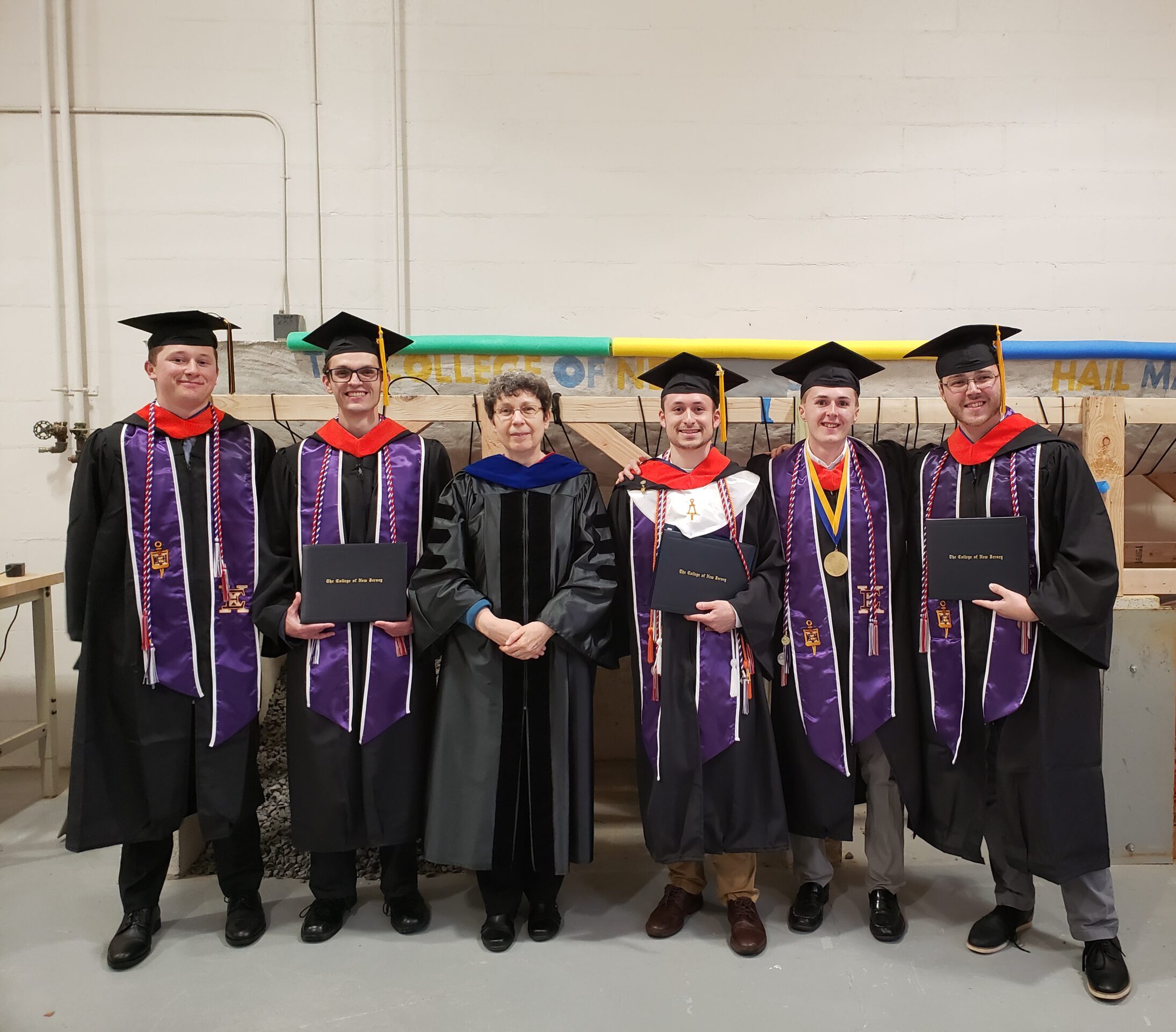 A group of people in cap and gowns standing.