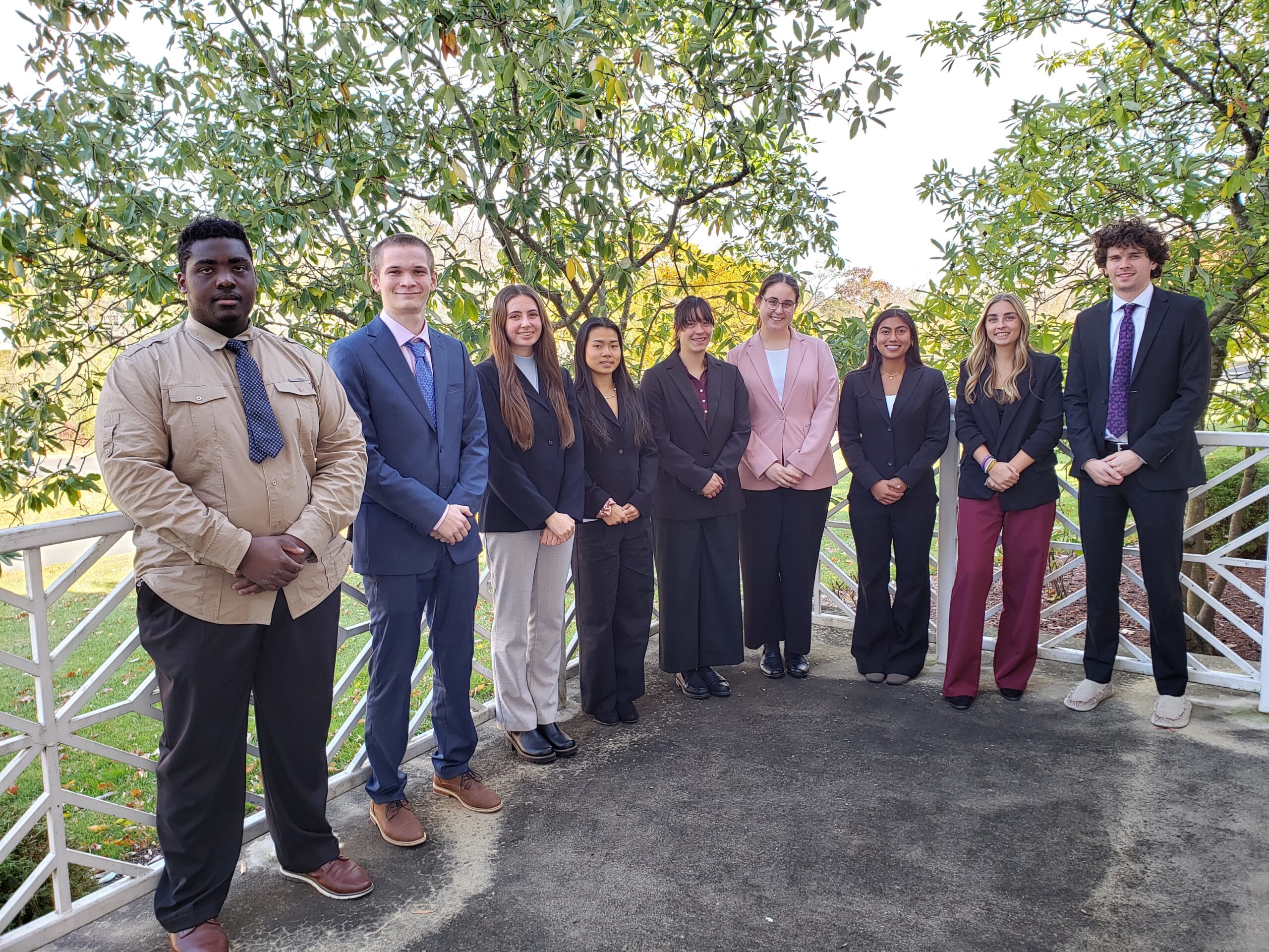 A group of students stand on a concrete patio